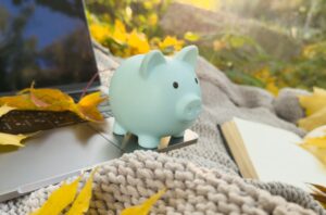 autumn. notebook, leaves, piggy bank, laptop