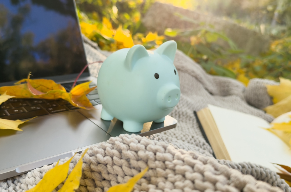 autumn. notebook, leaves, piggy bank, laptop