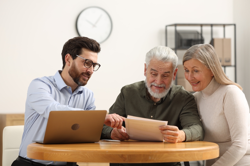 Notary consulting senior couple about Last Will and Testament in office